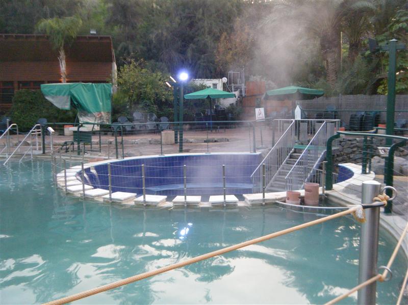 The small round area is down below (note steps) where you can sit under falling water
