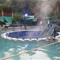 The small round area is down below (note steps) where you can sit under falling water
